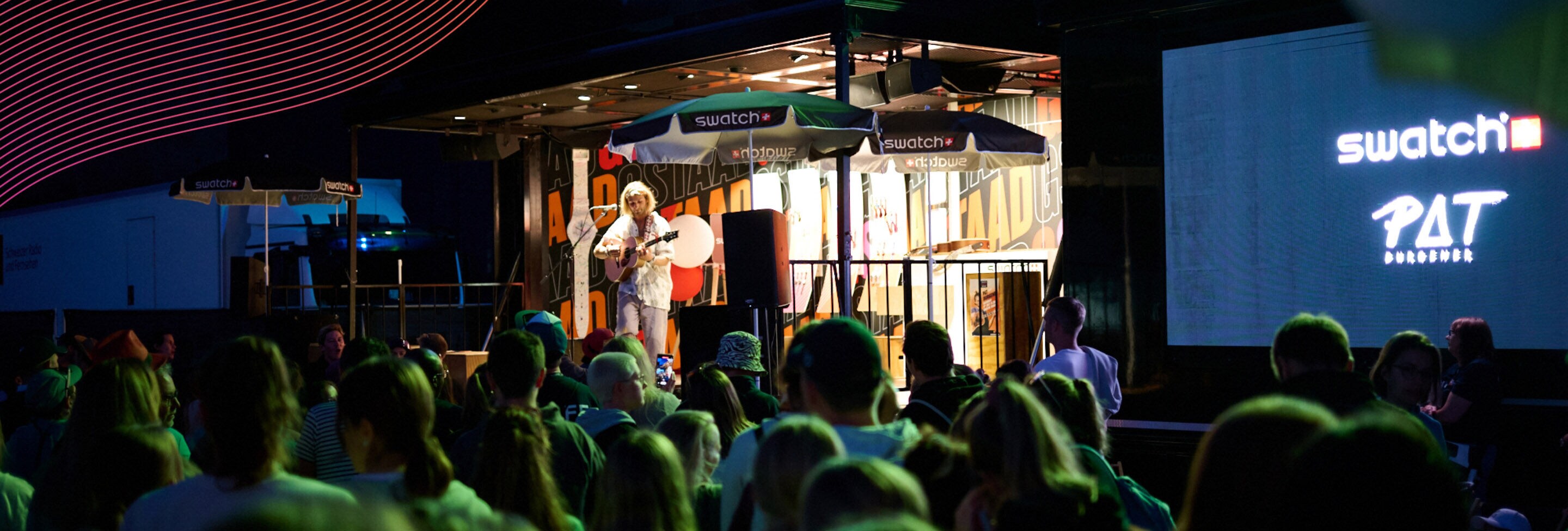 Pat Burgener with his guitar playing live from the Swatch Truck