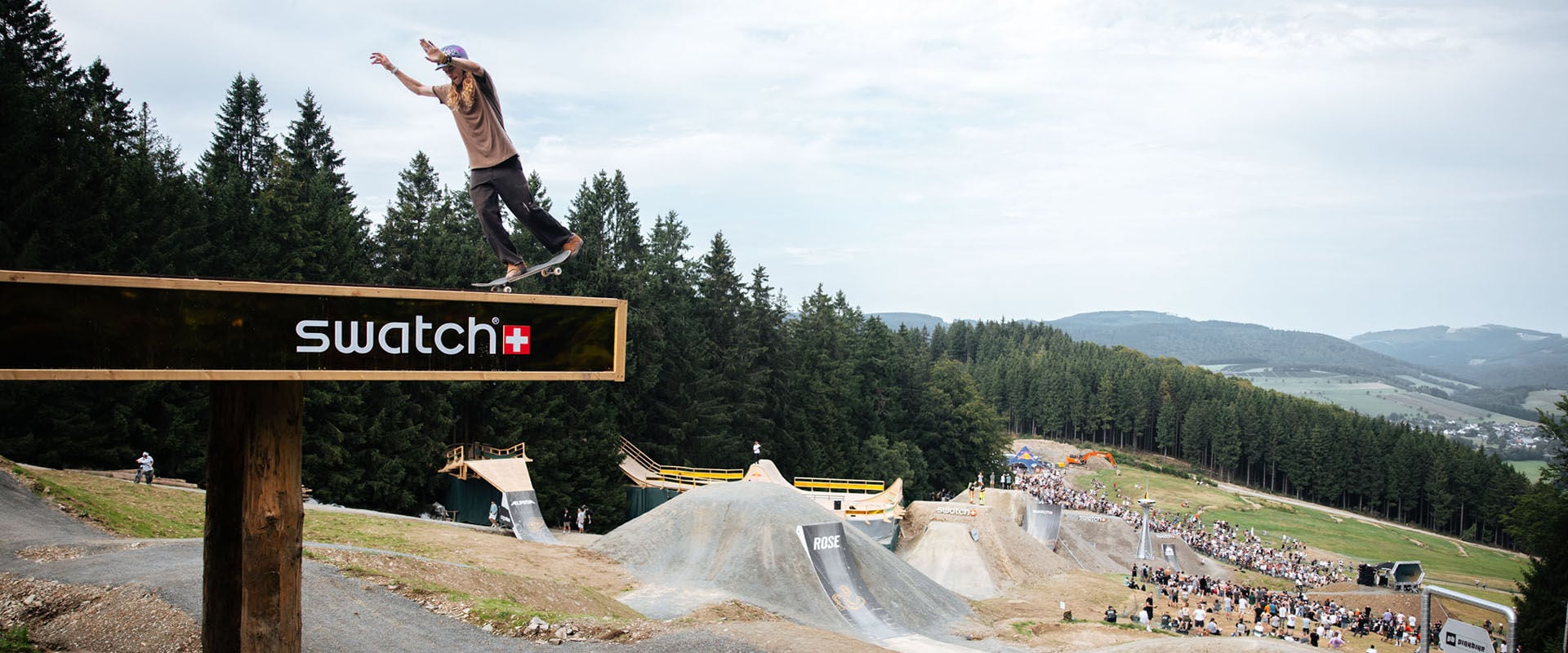 Andy Anderson skateboarding at the top of Swatch Nines