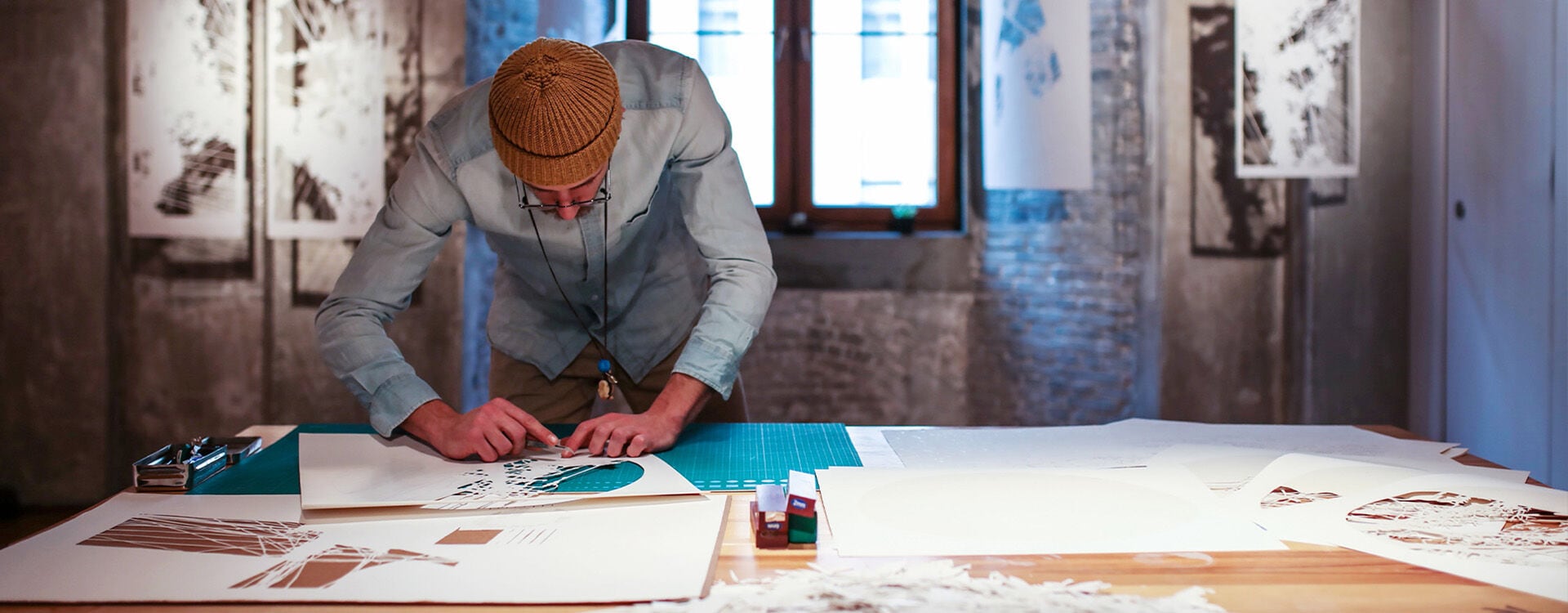 A man who is painting in the Swatch Art Peace Hotel