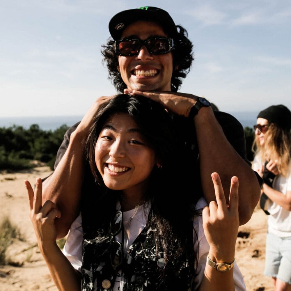 Swatch Proteam athletes Mami Tezuka and Kevin Peraza smiling on the beach