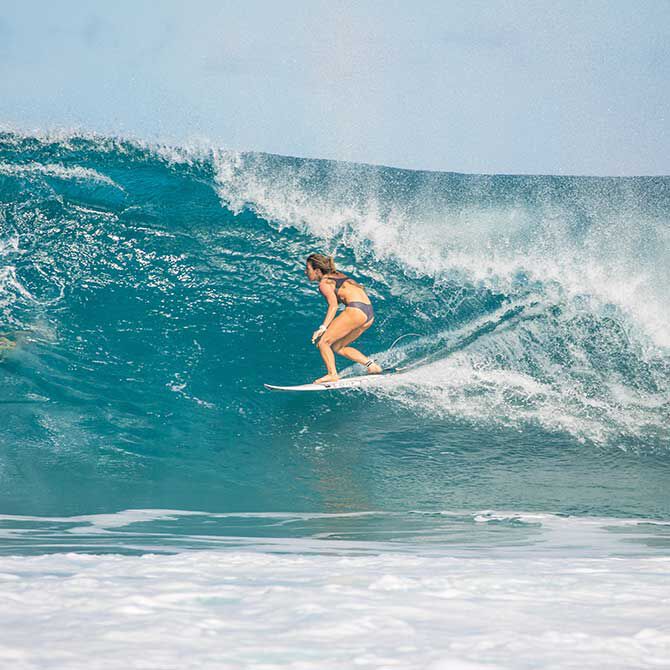 Coco Ho is riding a wave on the sea