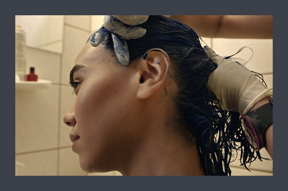 Woman getting her hair colored in blue