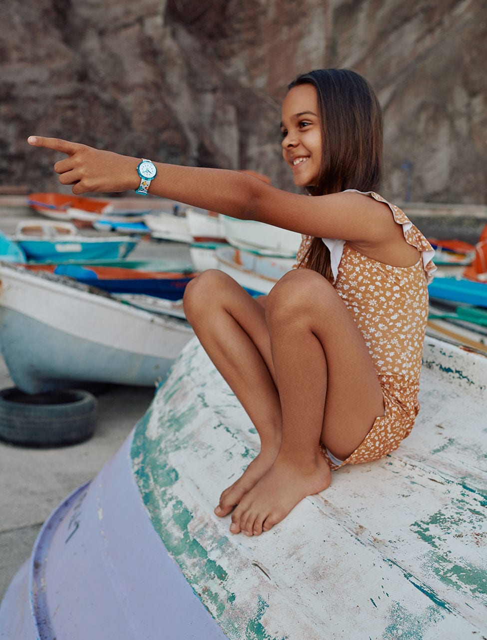Kid  on a boat wearing a watch from the collection Sea Treasure