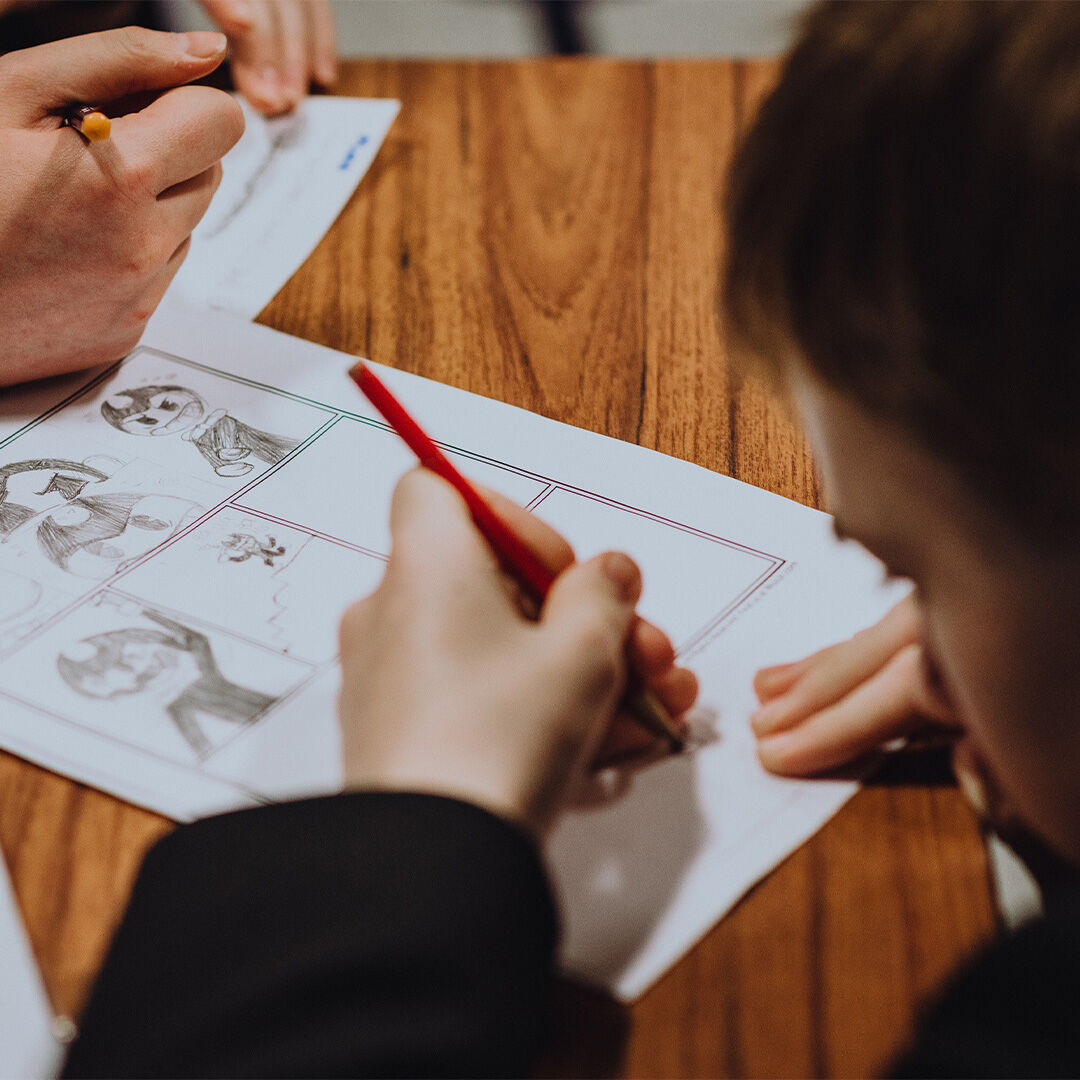 A child drawing a storyboard
