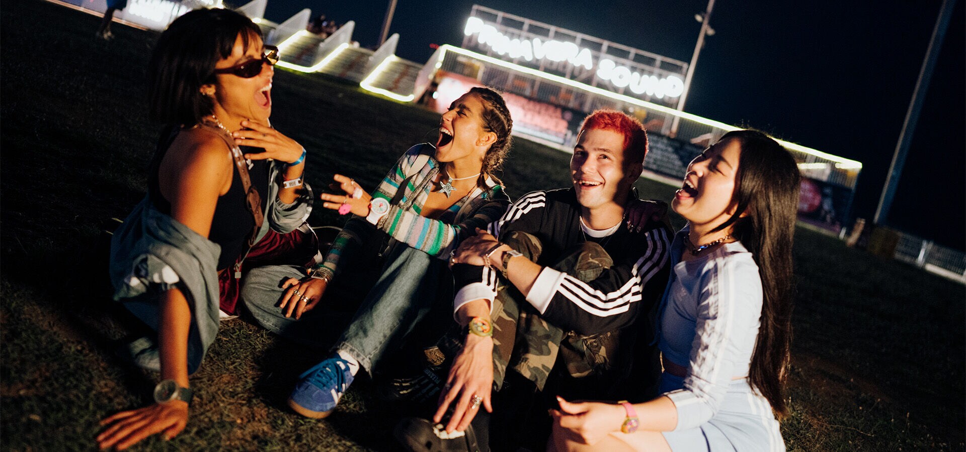 A group of friends chilling out sitting on the grass