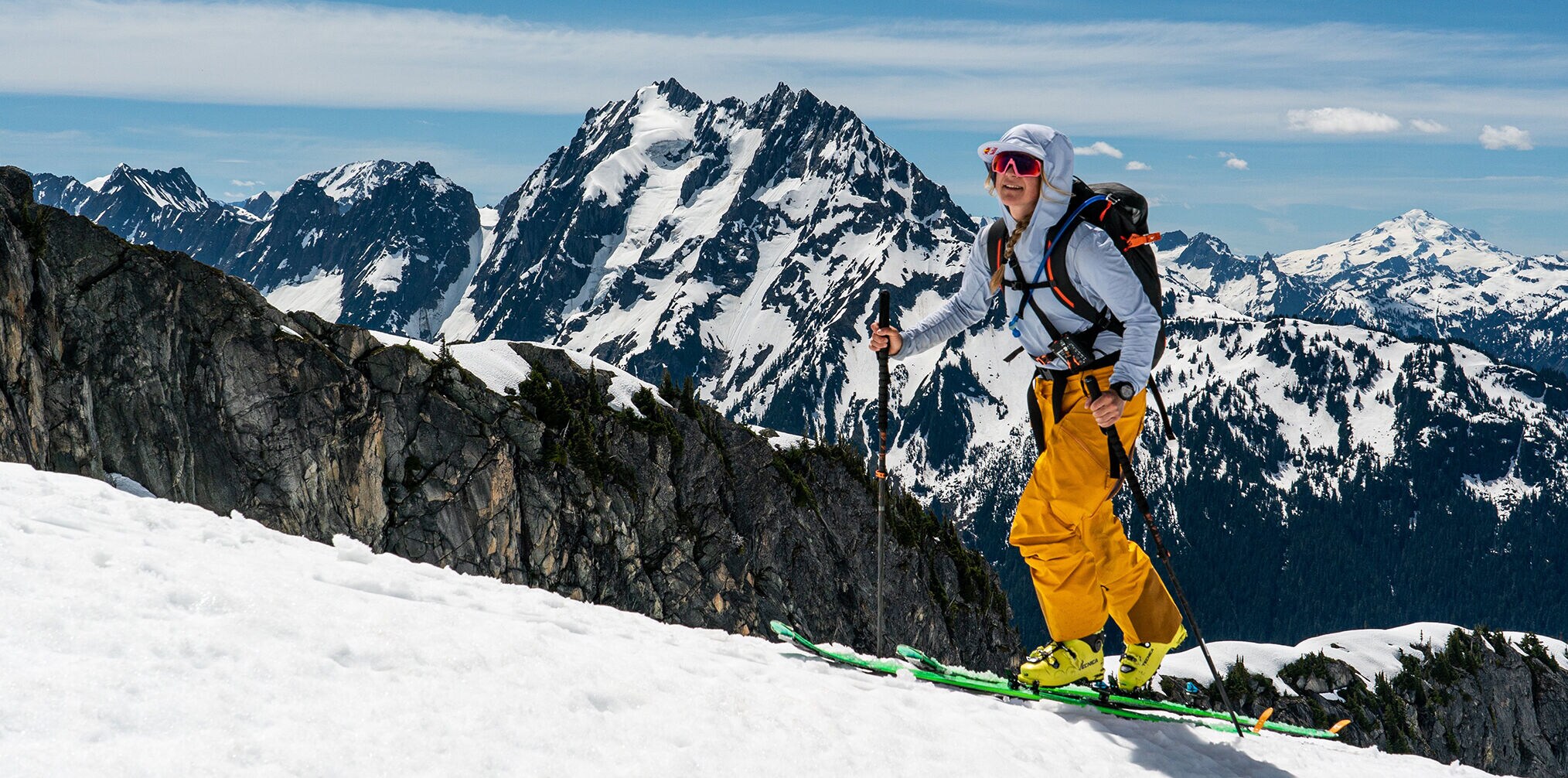 A woman is hiking with her ski on the mountain