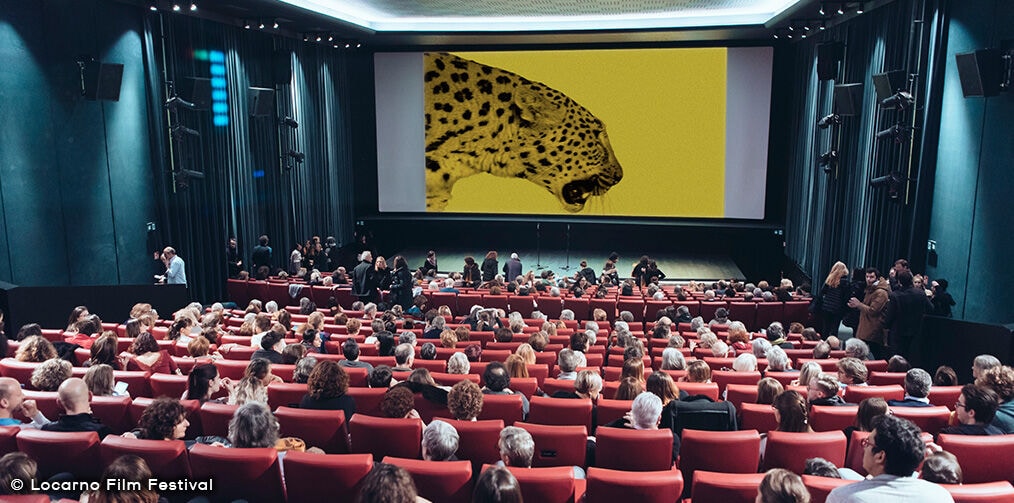 People watching a film projection inside a room