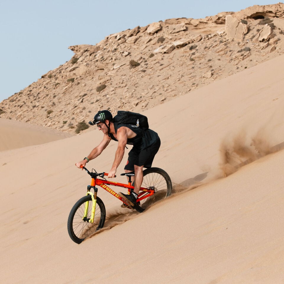 UK Proteam freeride MTB athlete Sam Pilgrim biking in the desert.