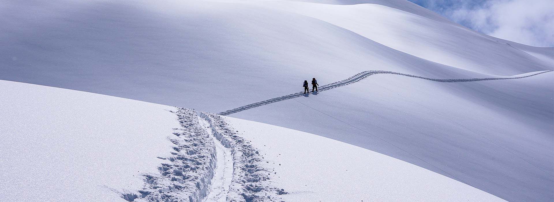Two people hiking in the snow